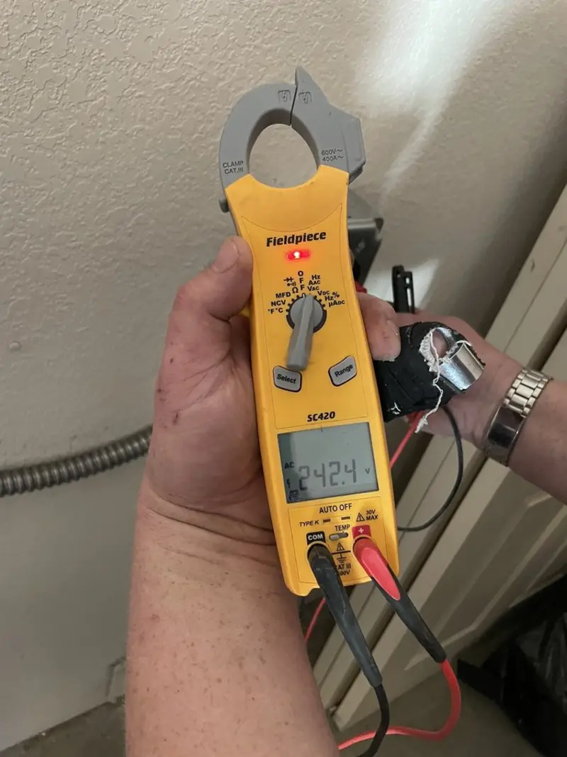 Voltage testing with clamp meter during Recessed Lighting Installation in Swanzey